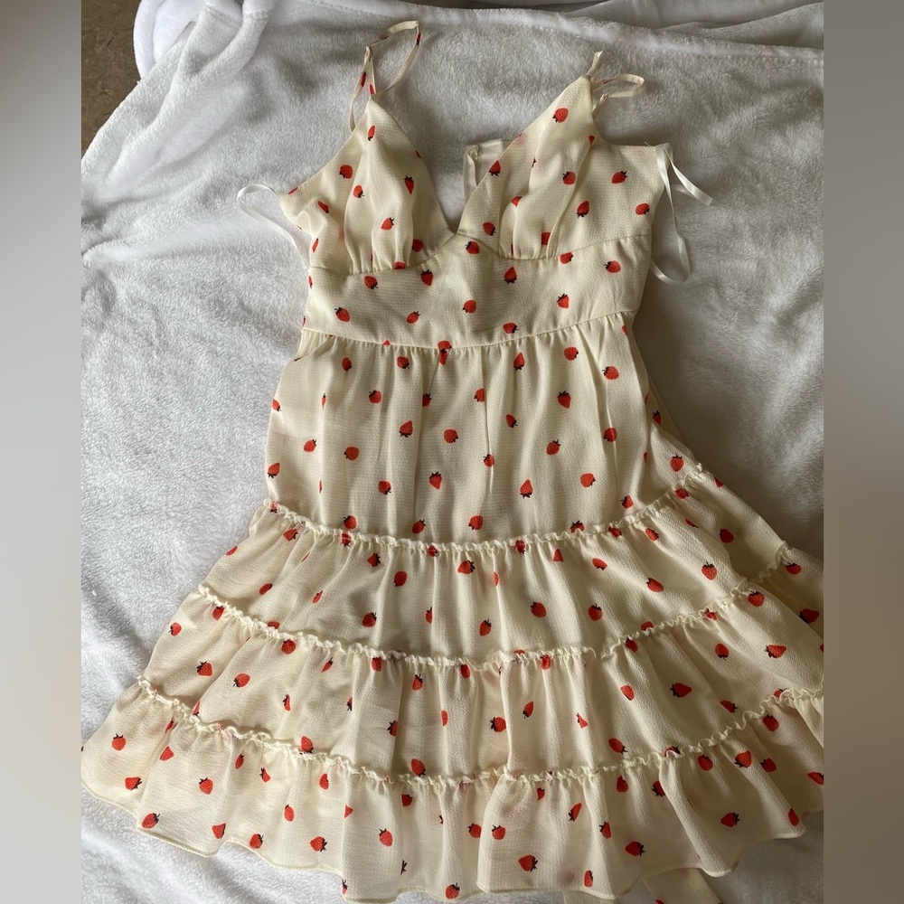 B. Smart like new dress beige color and size 11 with strawberry print.